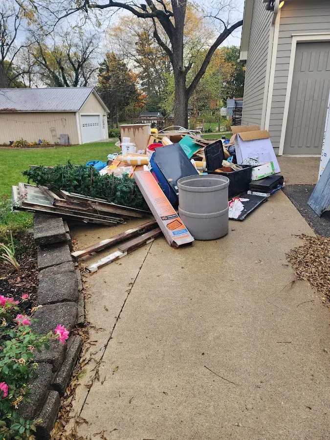 Dumpster being loaded with debris for Estate Cleanout Dumpster Rental in High Springs